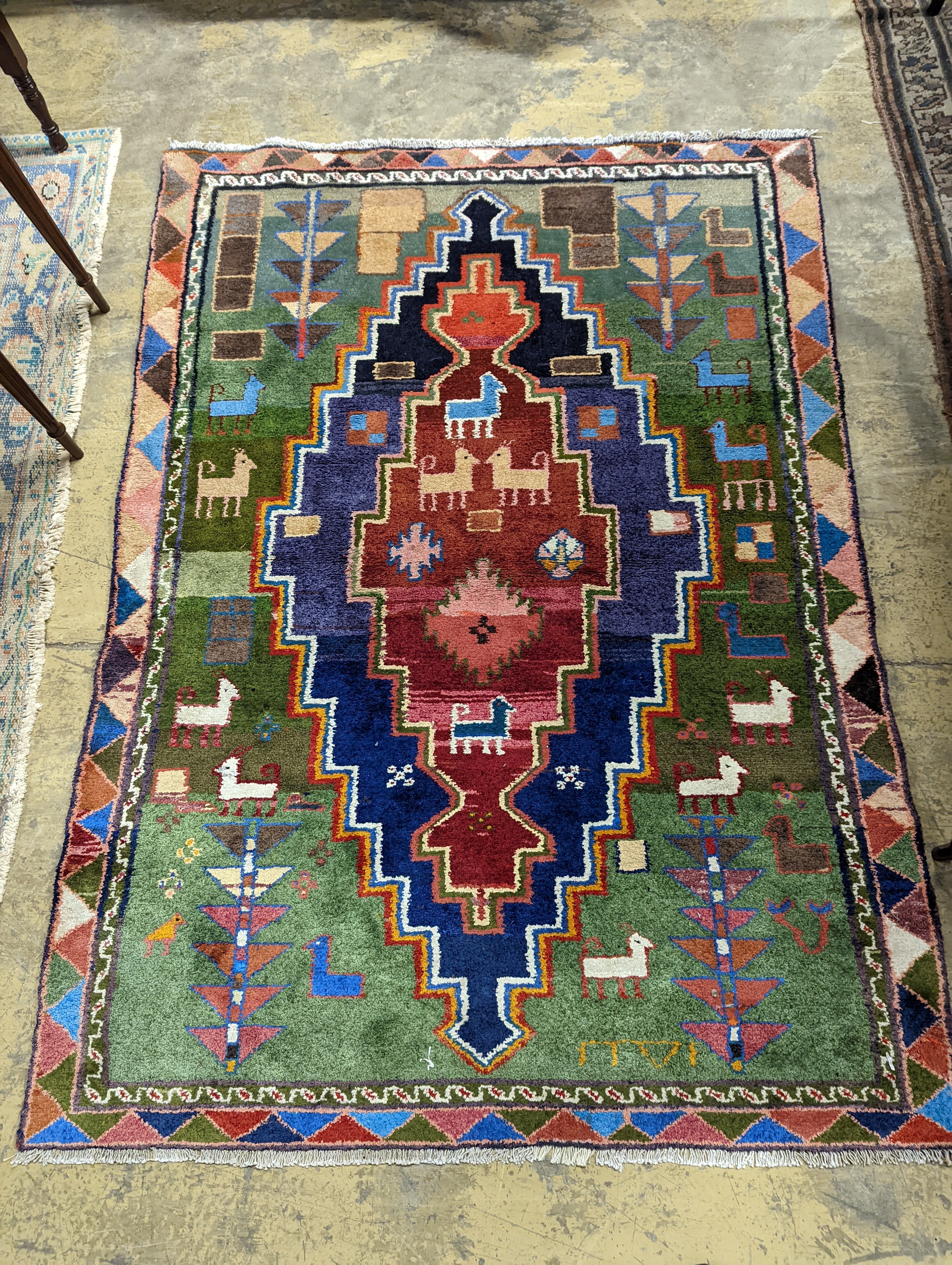 A Caucasian design blue ground rug, 180 x 128cm